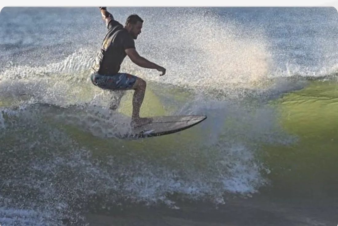 Andrew Davis surfing on the Topsail coast